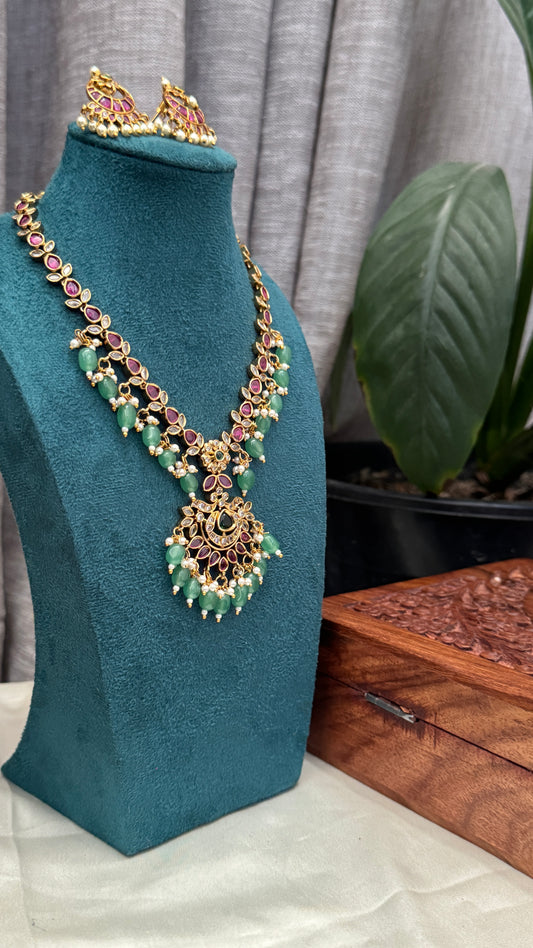 Temple Jewellery with emerald, ruby and white color stone details.