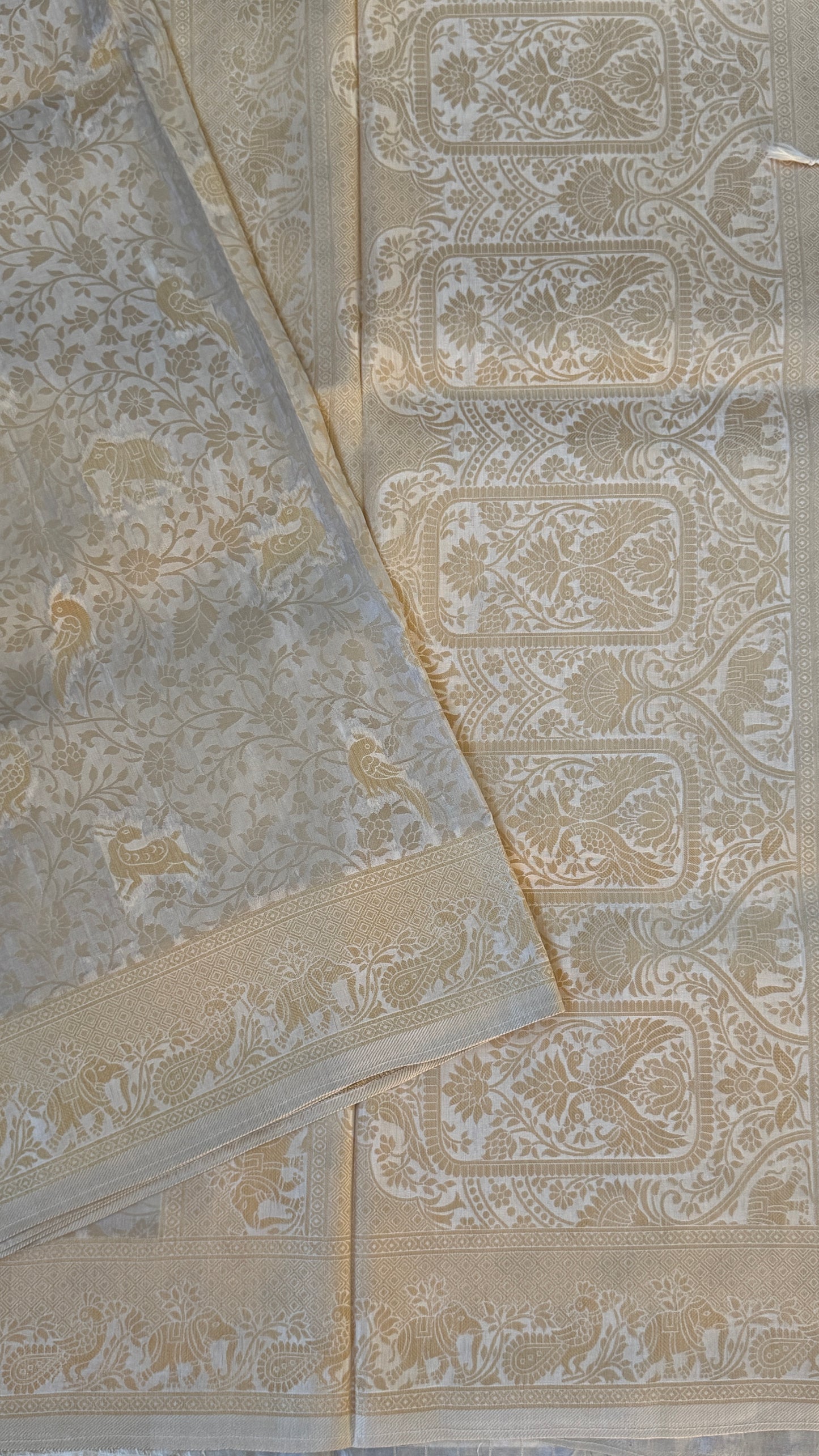 Soft Tissue Silk Saree in Half White Shade with Intricate Animal Motifs