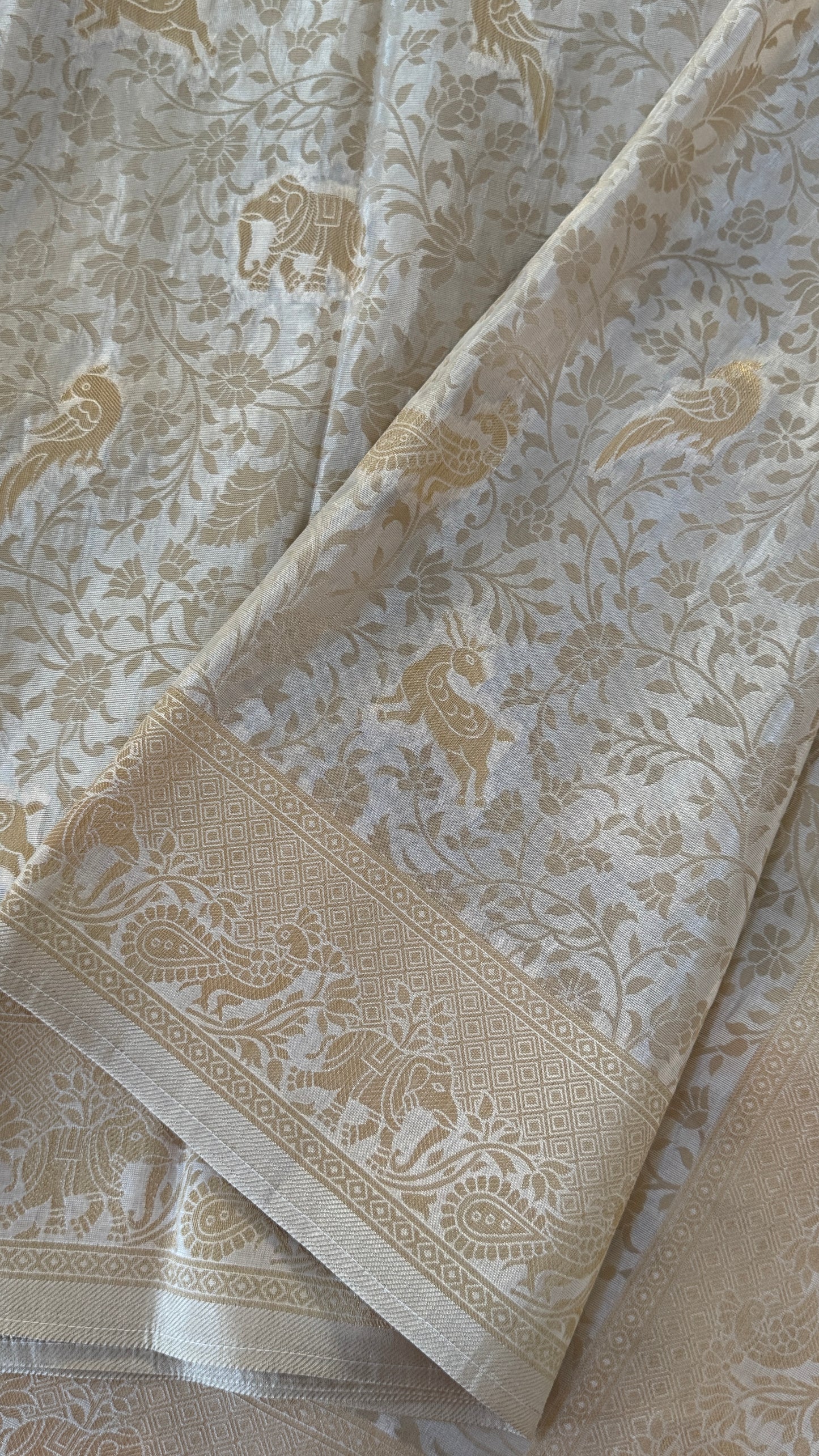 Soft Tissue Silk Saree in Half White Shade with Intricate Animal Motifs