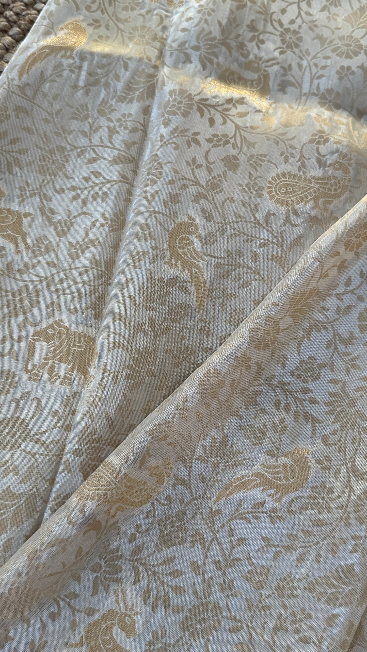 Soft Tissue Silk Saree in Half White Shade with Intricate Animal Motifs