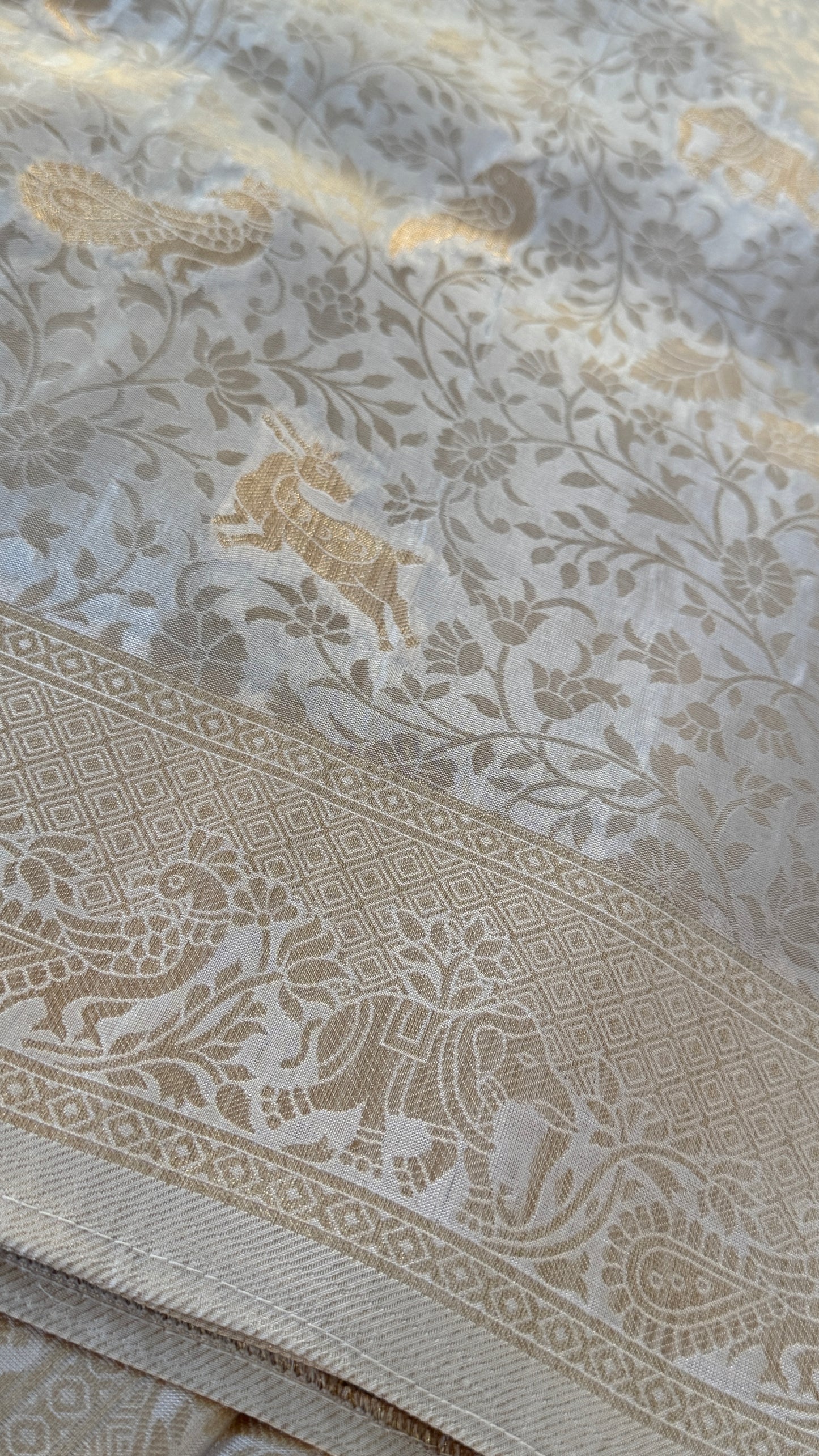 Soft Tissue Silk Saree in Half White Shade with Intricate Animal Motifs