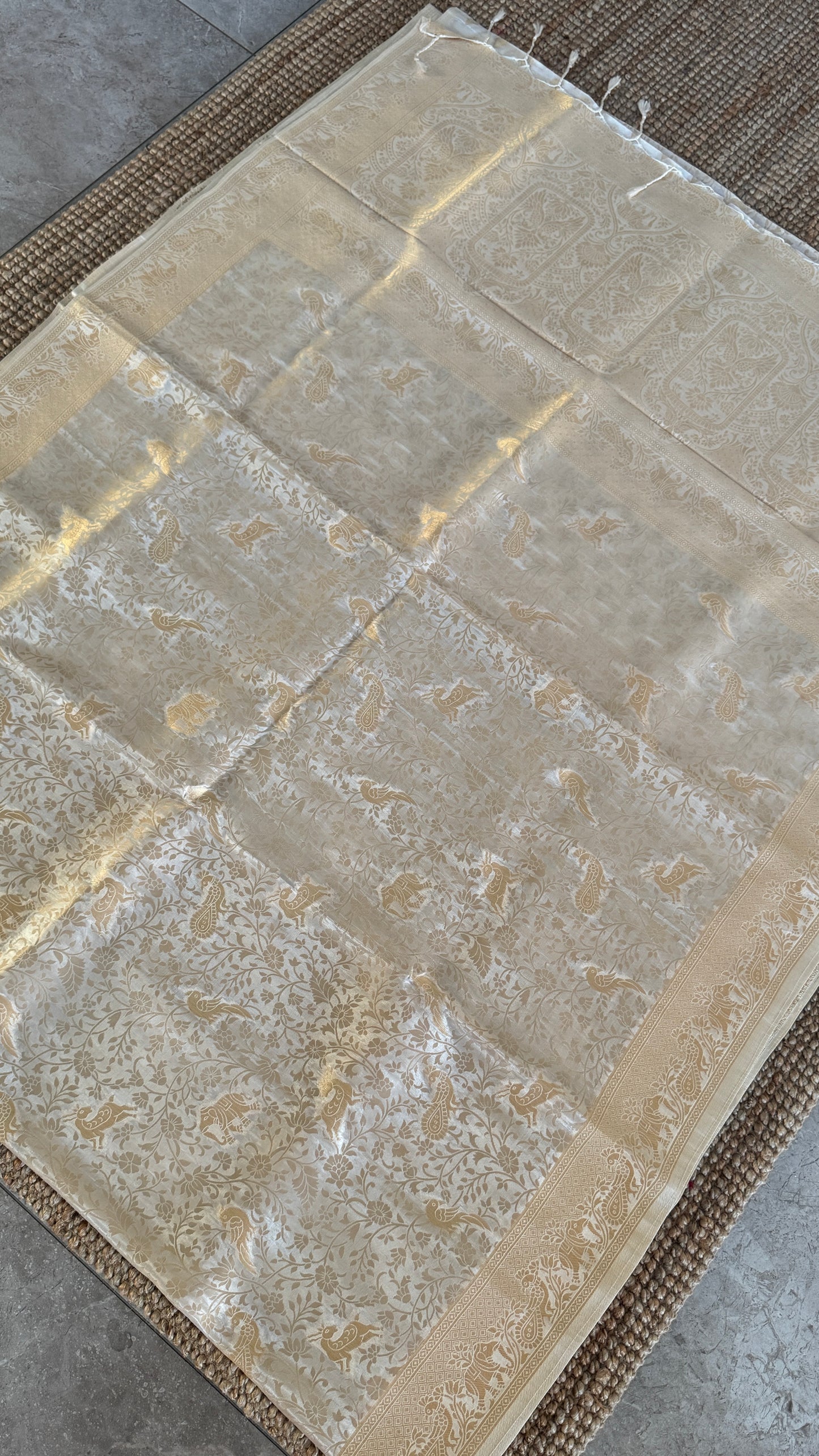 Soft Tissue Silk Saree in Half White Shade with Intricate Animal Motifs