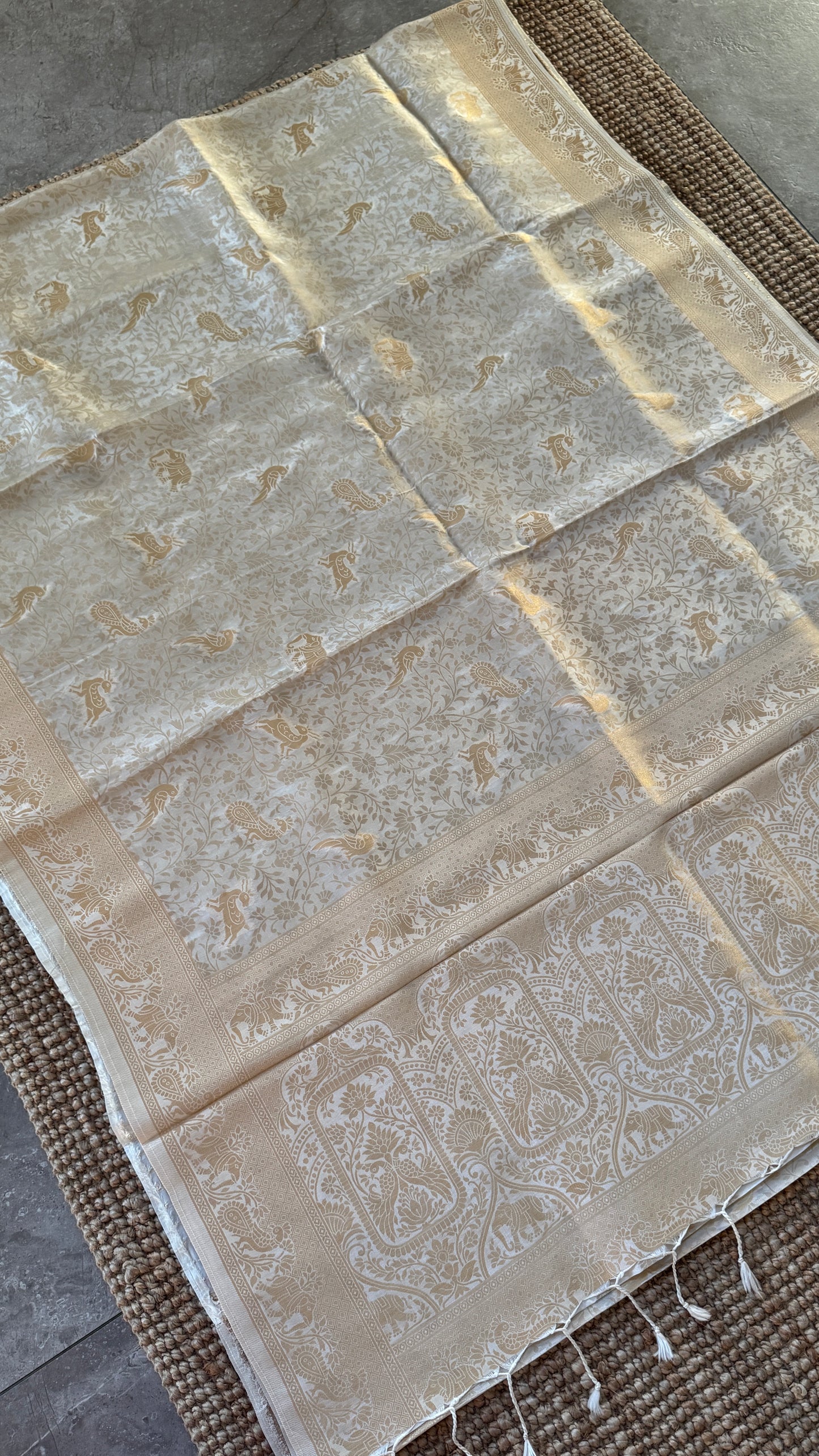 Soft Tissue Silk Saree in Half White Shade with Intricate Animal Motifs