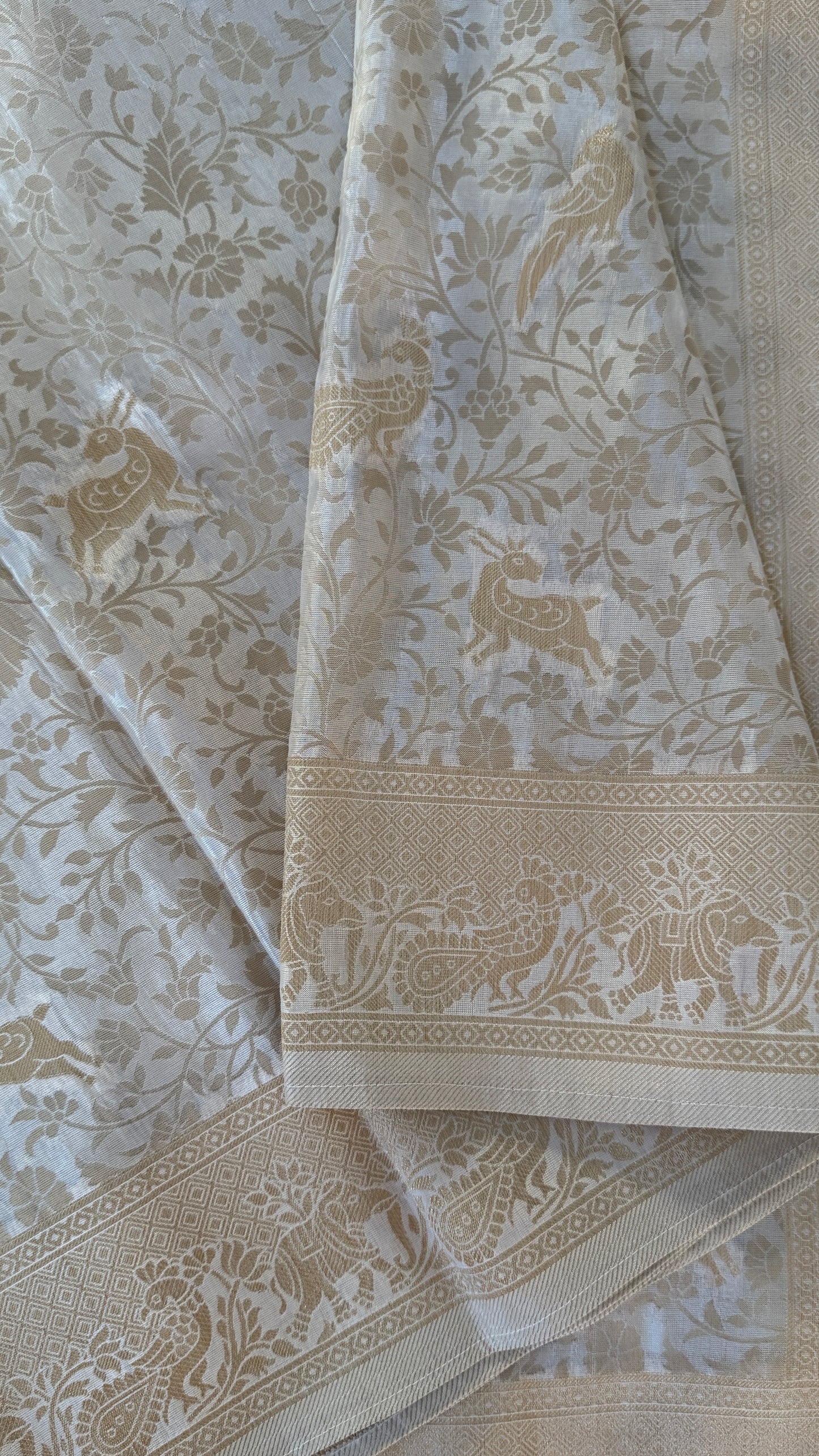Soft Tissue Silk Saree in Half White Shade with Intricate Animal Motifs