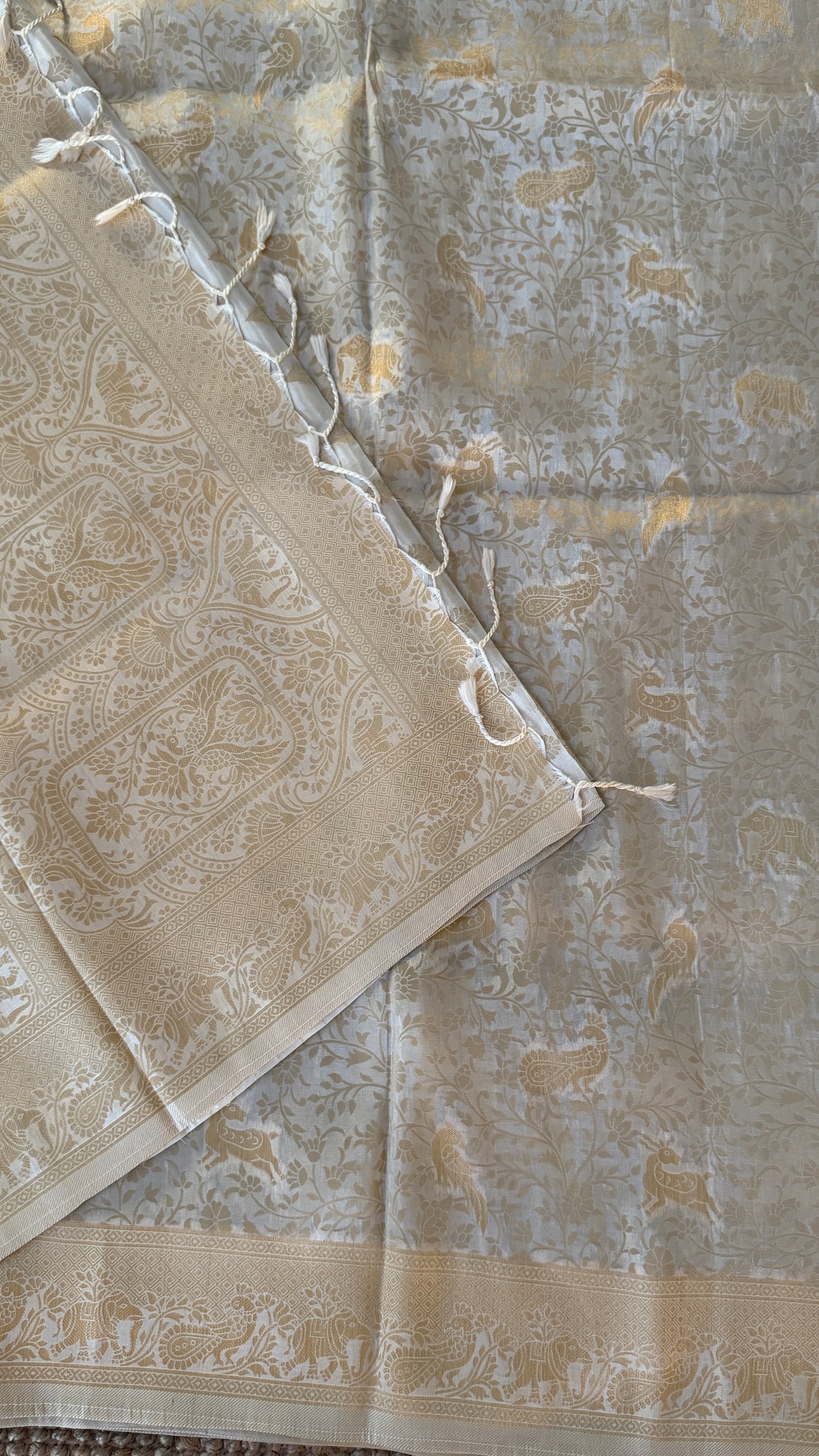 Soft Tissue Silk Saree in Half White Shade with Intricate Animal Motifs