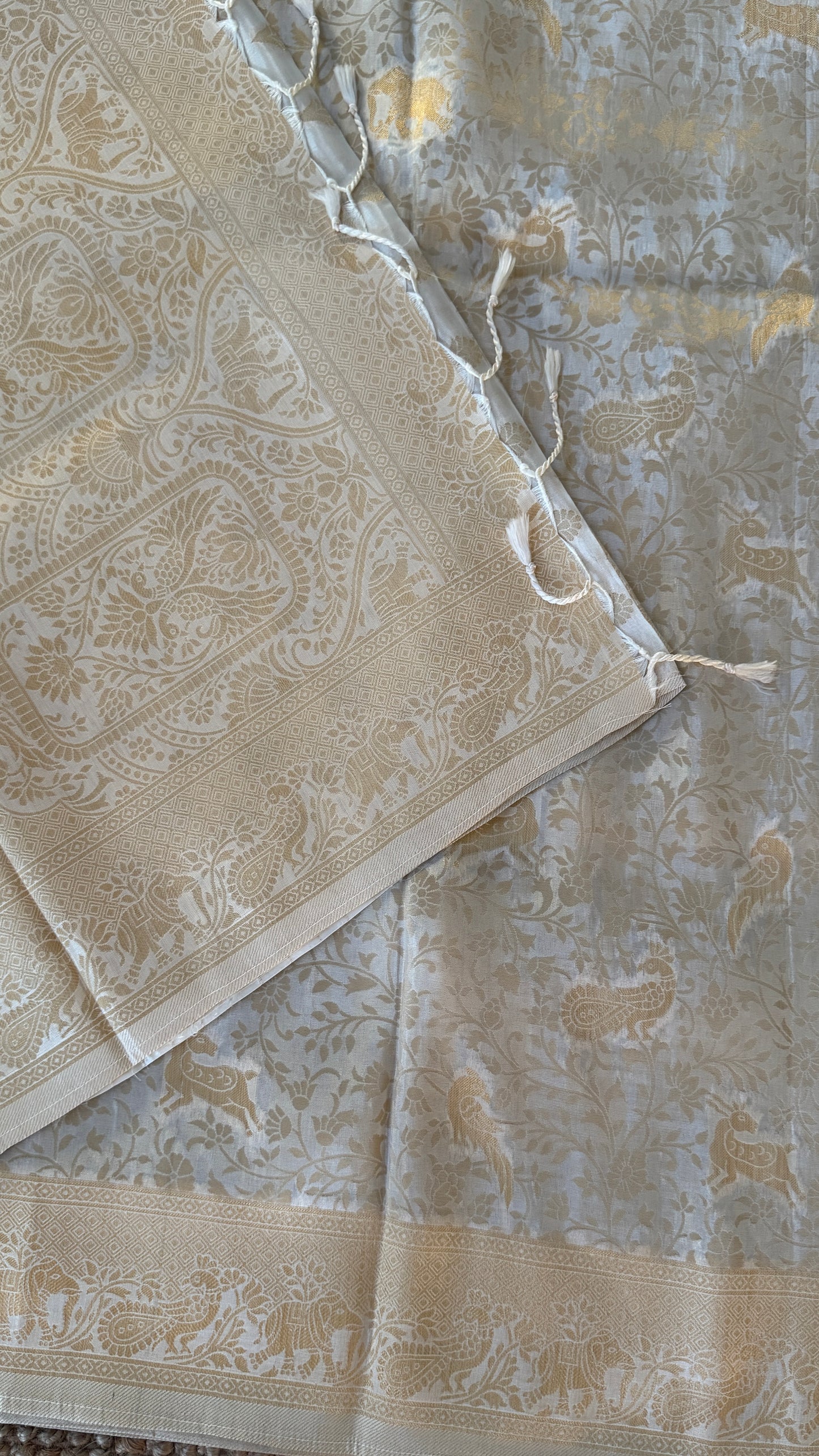 Soft Tissue Silk Saree in Half White Shade with Intricate Animal Motifs