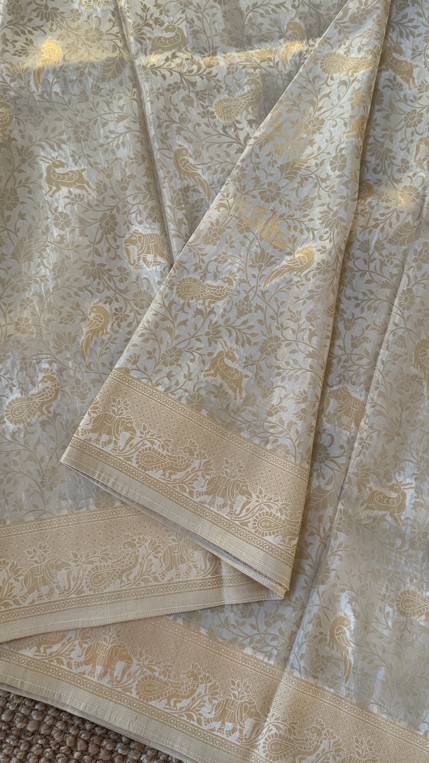 Soft Tissue Silk Saree in Half White Shade with Intricate Animal Motifs