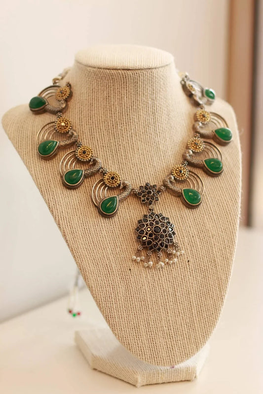 Beautiful German silver peacock design necklace set with gold and emerald color stone details