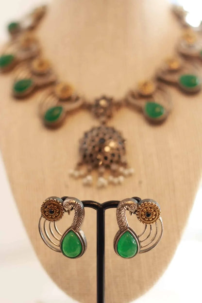 Beautiful German silver peacock design necklace set with gold and emerald color stone details