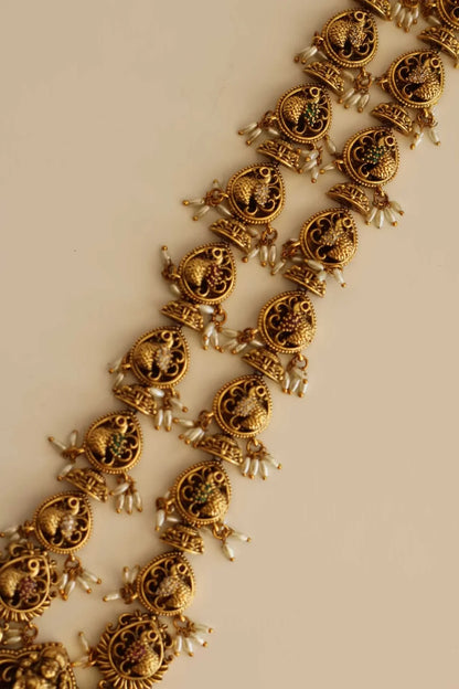 Long Bridal Temple Jewellery with pearl emerald,and ruby color stone details.