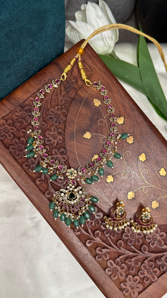 Temple Jewellery with emerald, ruby and white color stone details.