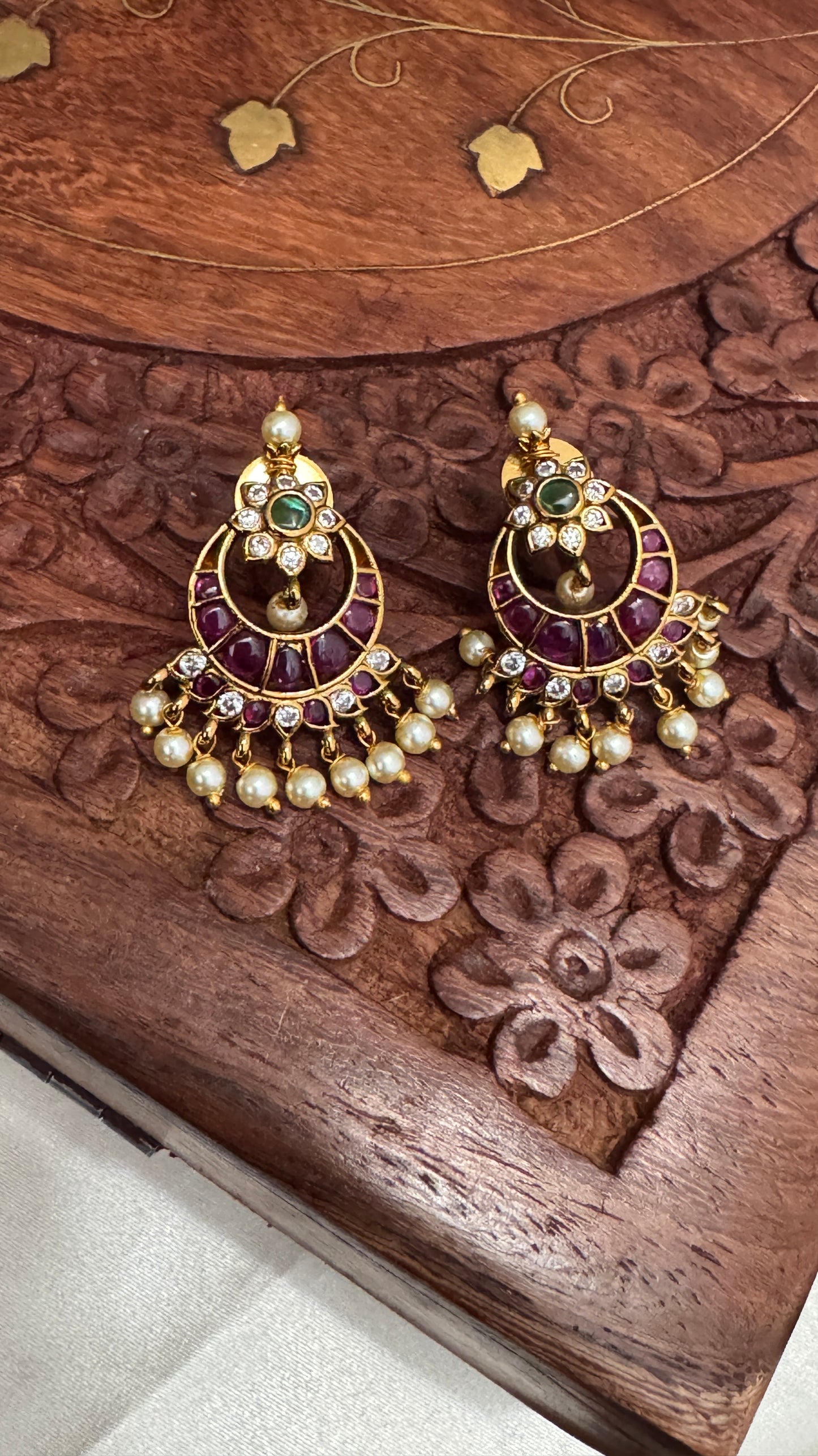 Temple Jewellery with emerald, ruby and white color stone details.