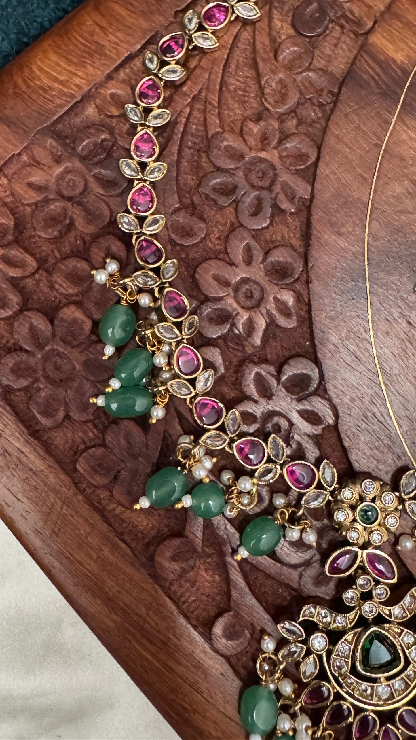 Temple Jewellery with emerald, ruby and white color stone details.