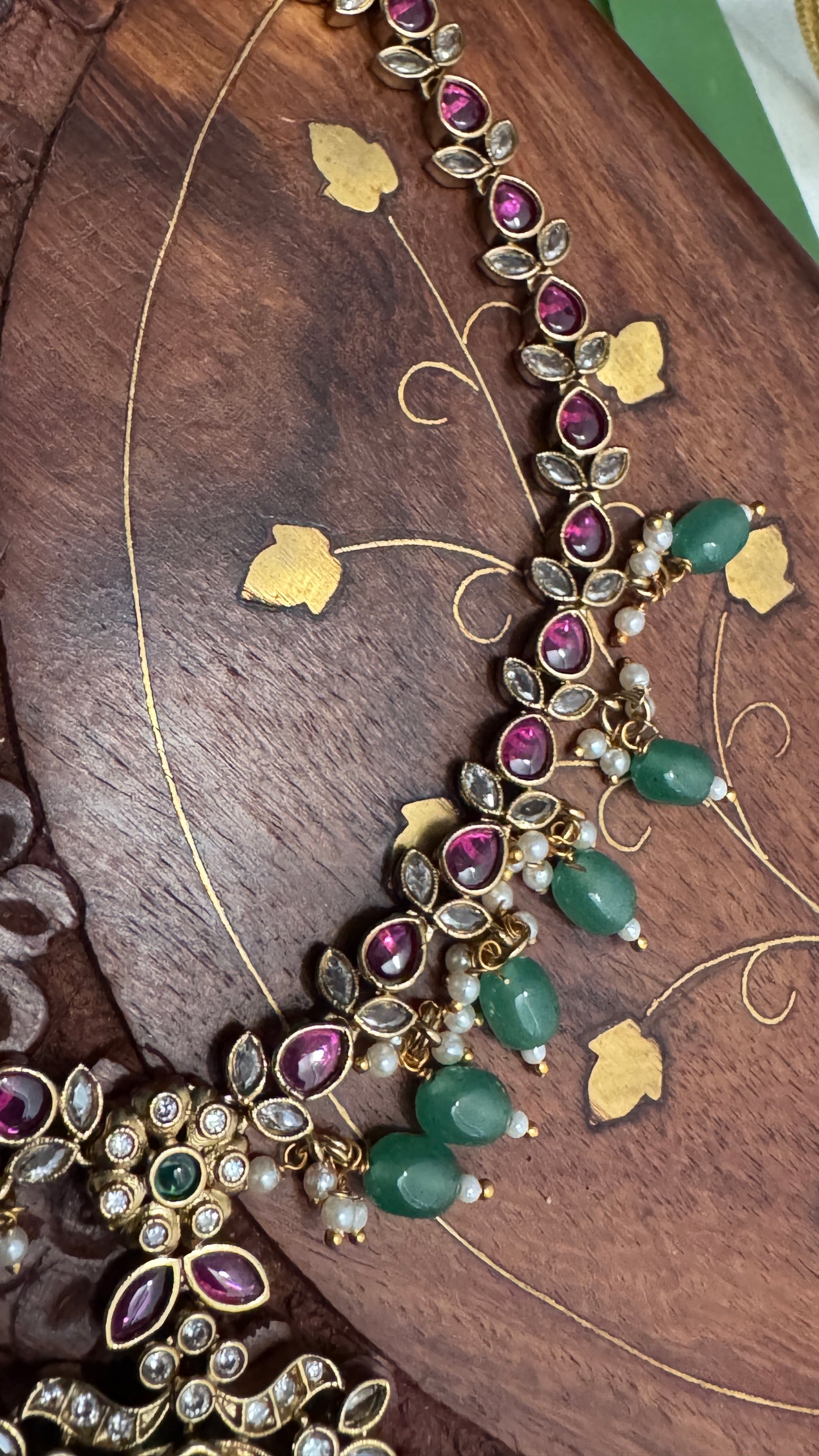 Temple Jewellery with emerald, ruby and white color stone details.