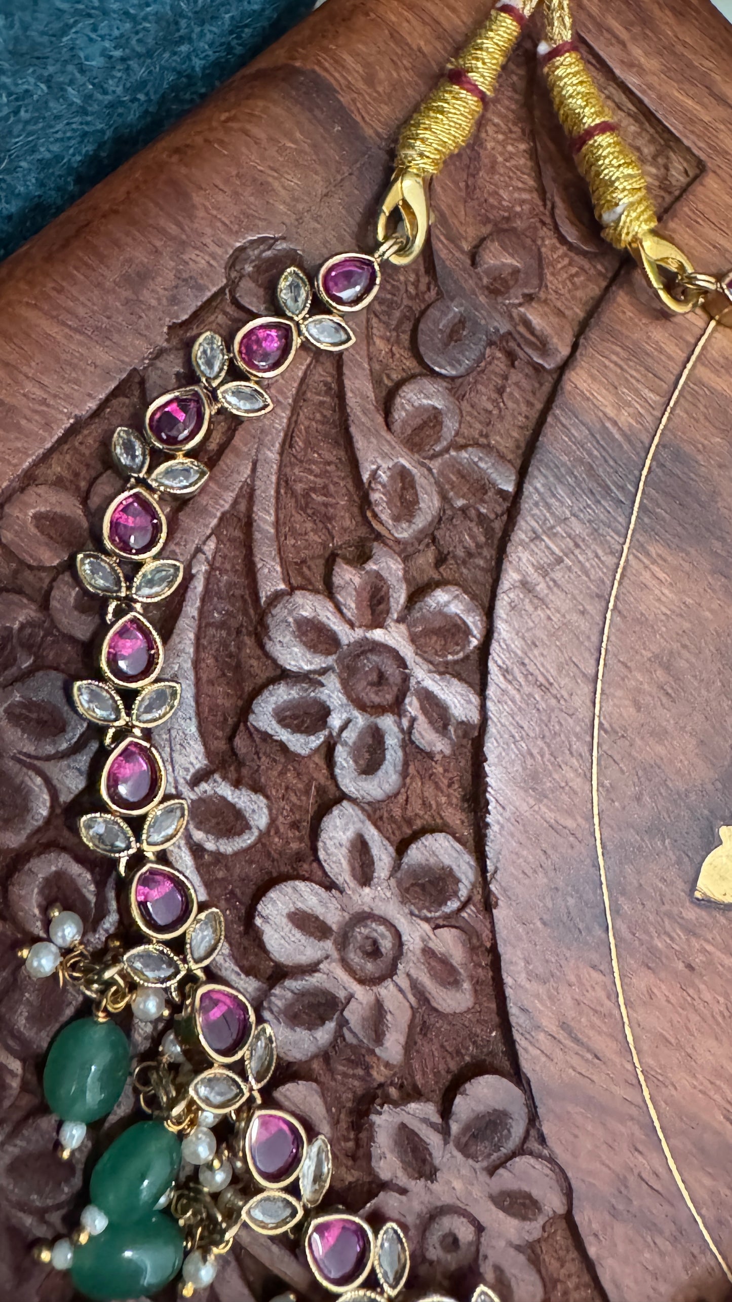 Temple Jewellery with emerald, ruby and white color stone details.