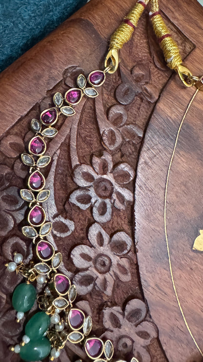 Temple Jewellery with emerald, ruby and white color stone details.
