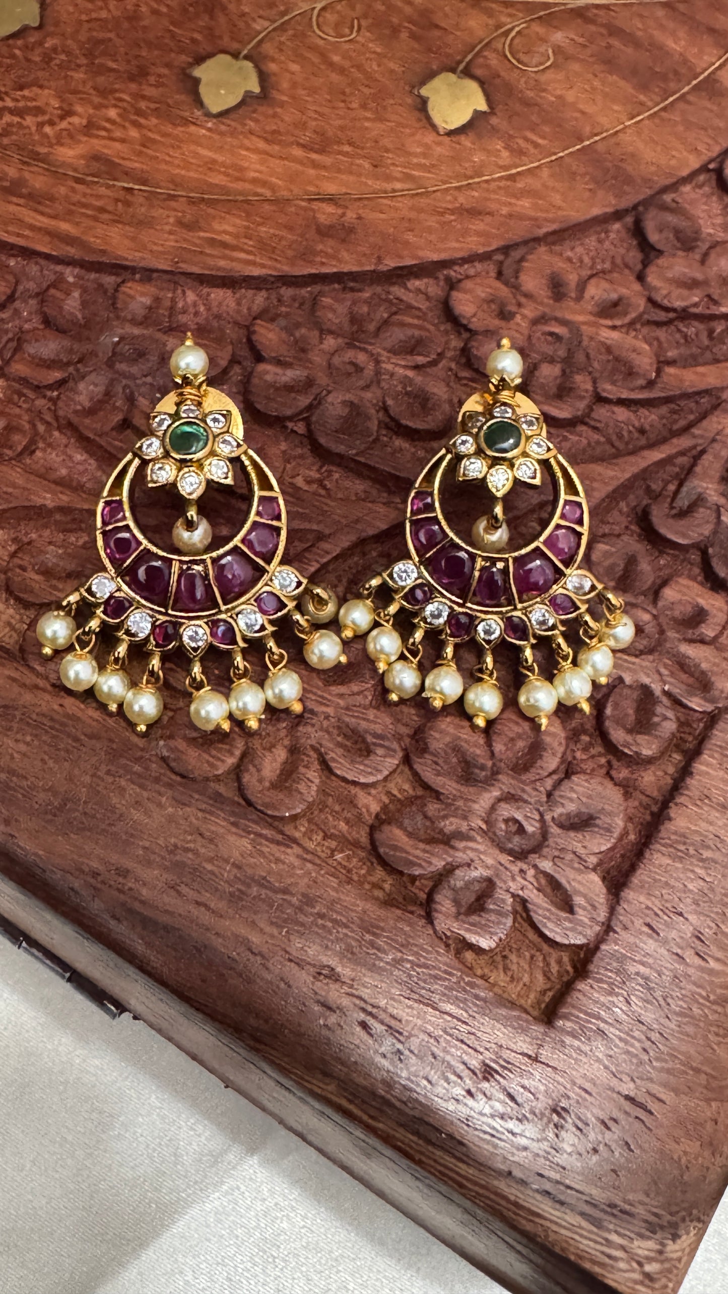 Temple Jewellery with emerald, ruby and white color stone details.
