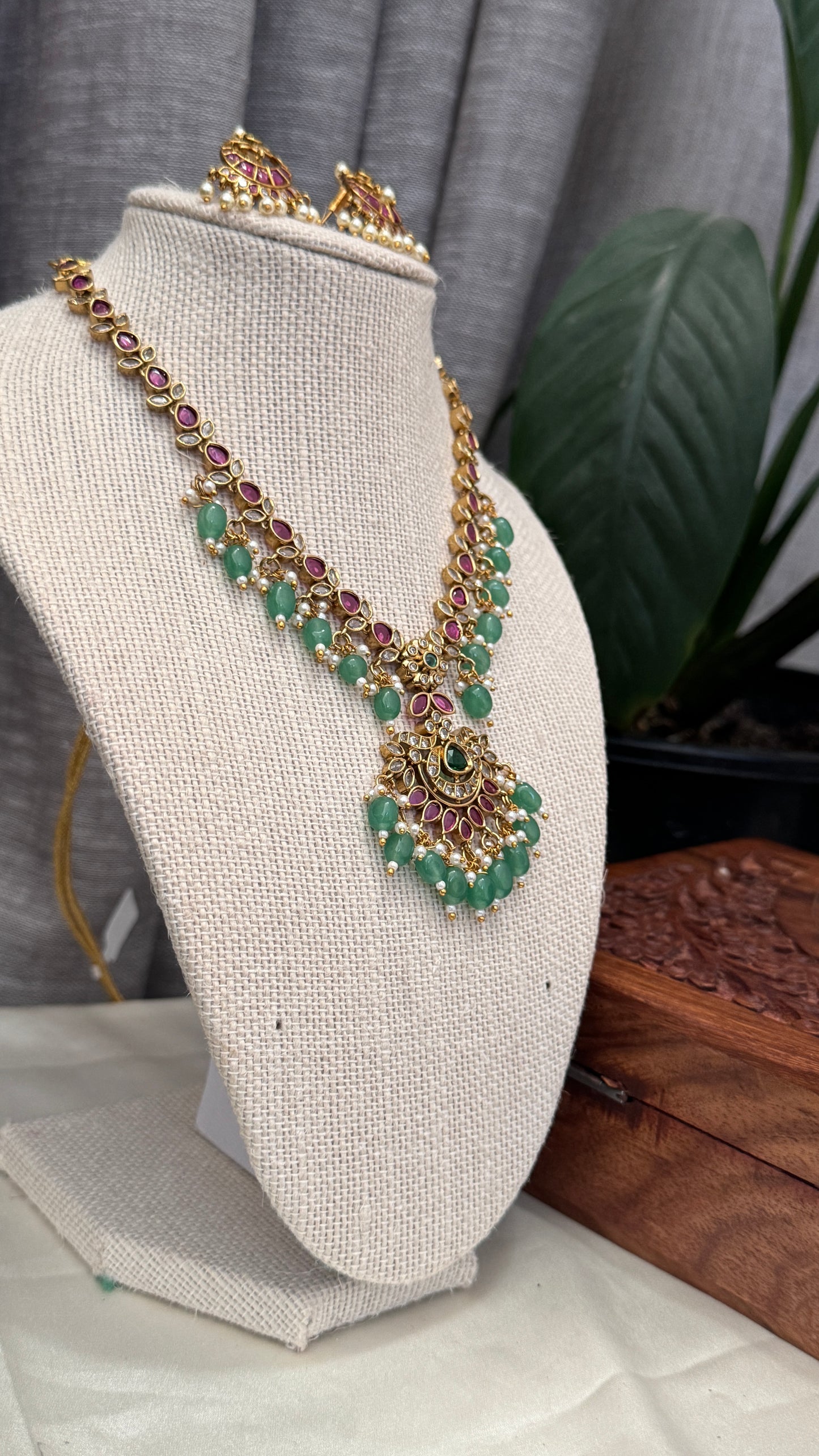 Temple Jewellery with emerald, ruby and white color stone details.