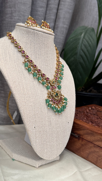 Temple Jewellery with emerald, ruby and white color stone details.