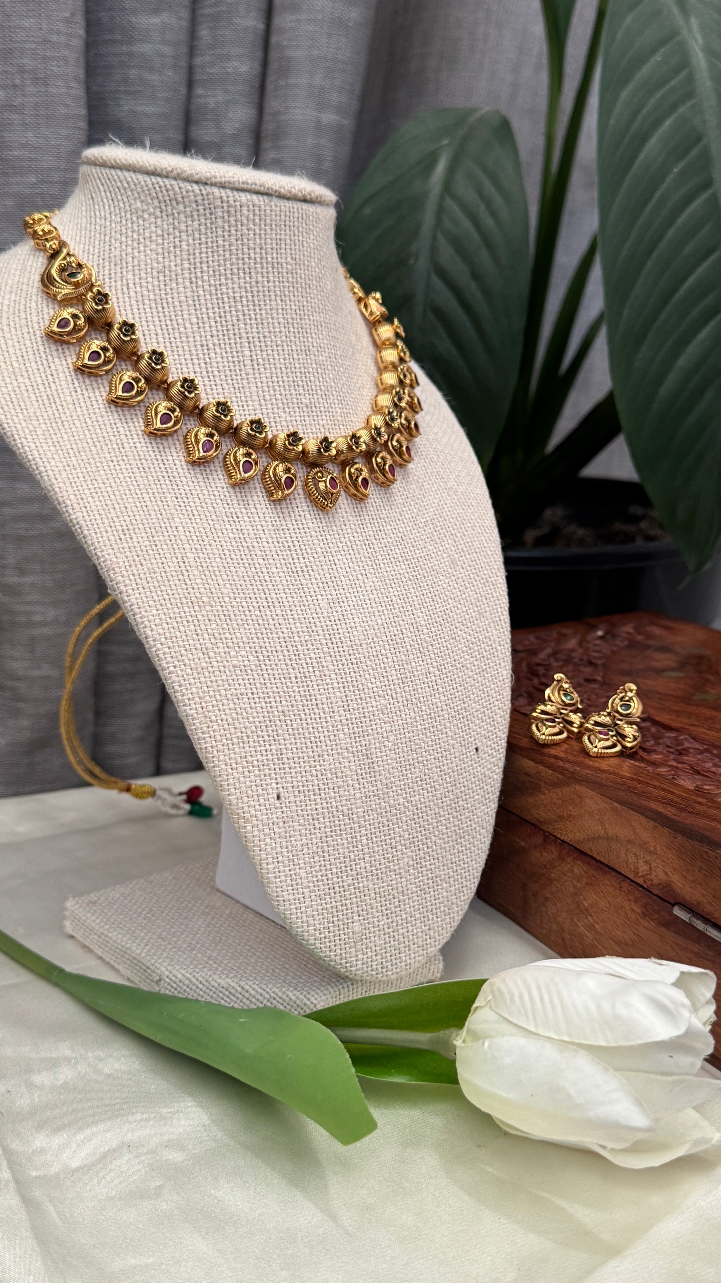 Temple Jewellery with emerald, ruby and white color stone details.