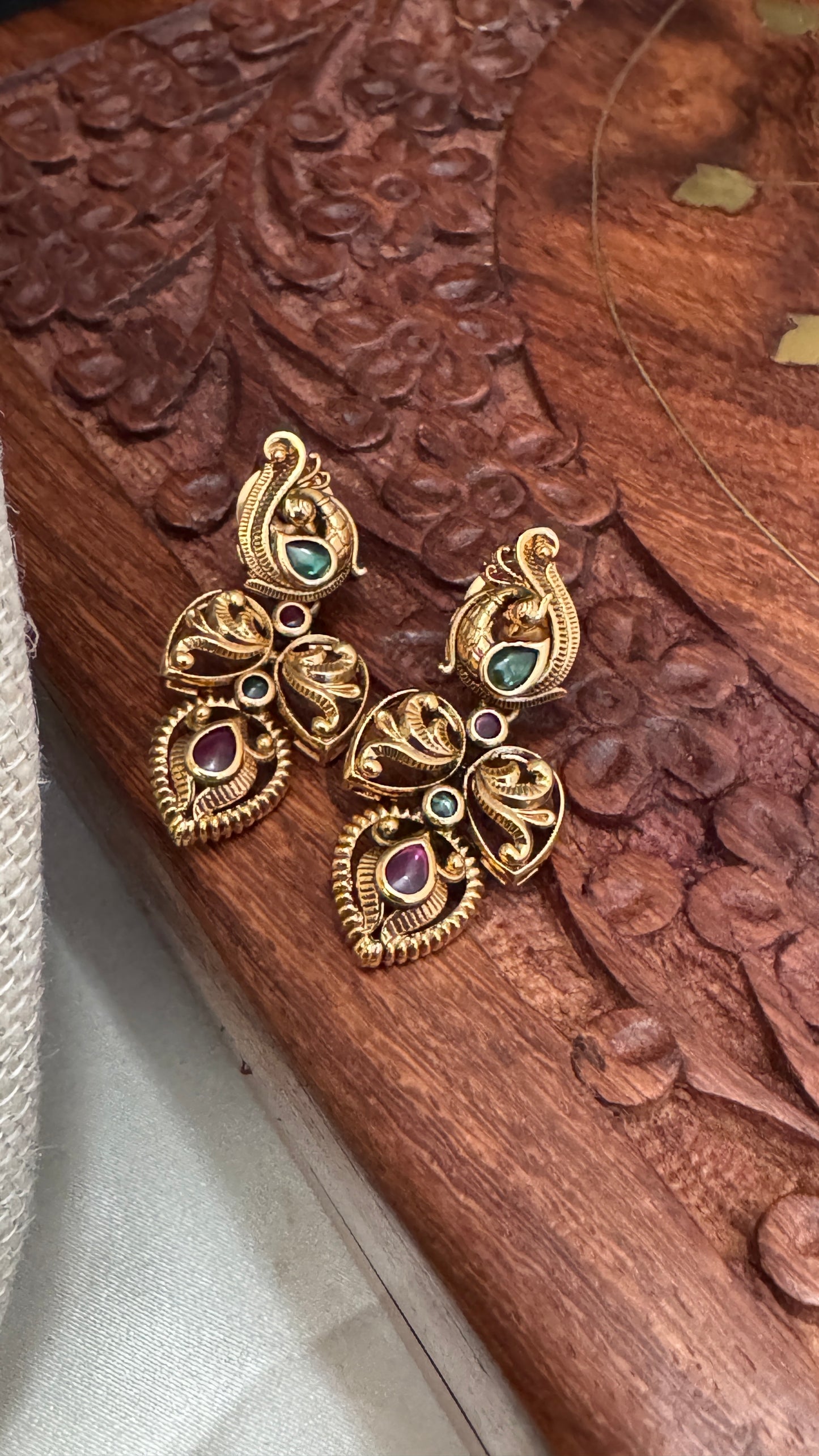 Temple Jewellery with emerald, ruby and white color stone details.
