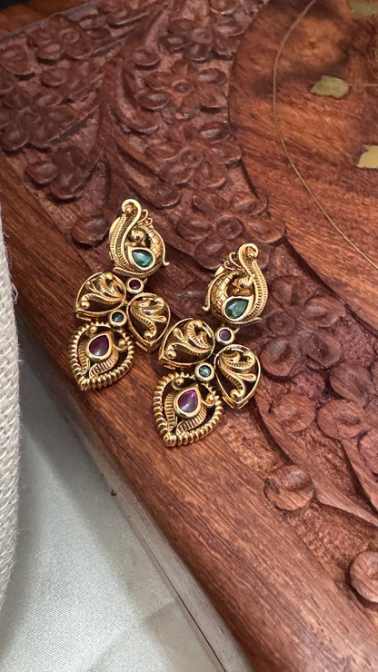 Temple Jewellery with emerald, ruby and white color stone details.