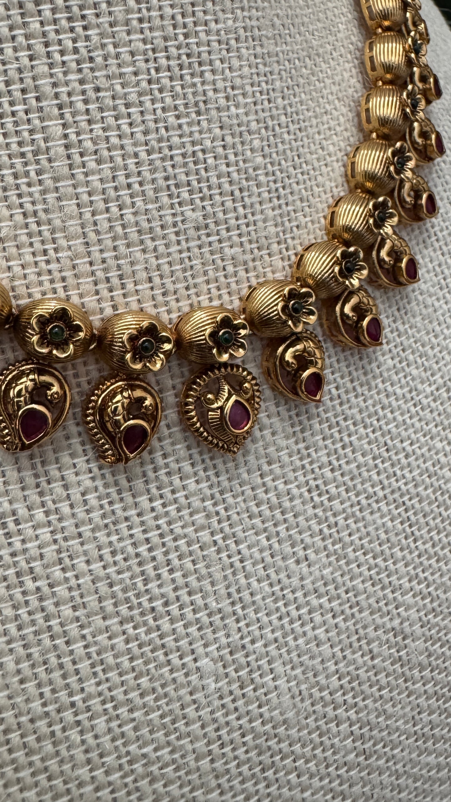 Temple Jewellery with emerald, ruby and white color stone details.