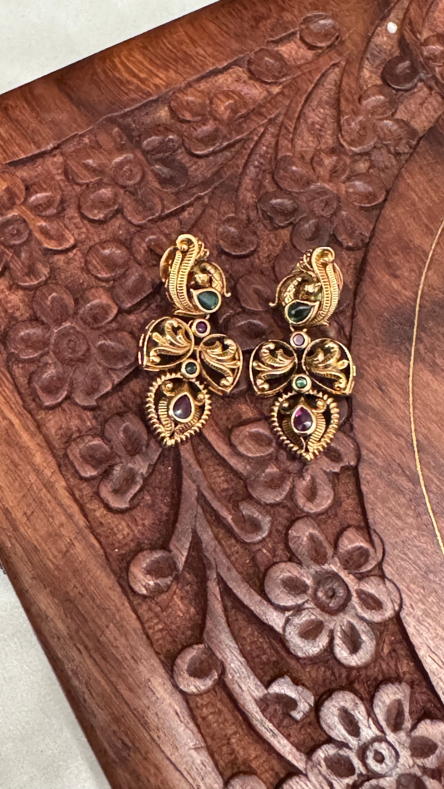 Temple Jewellery with emerald, ruby and white color stone details.