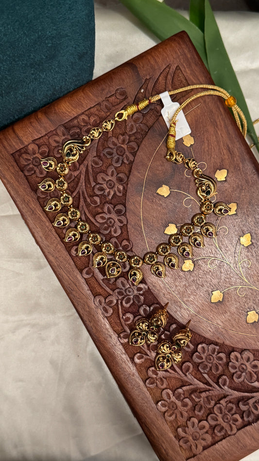 Temple Jewellery with emerald, ruby and white color stone details.