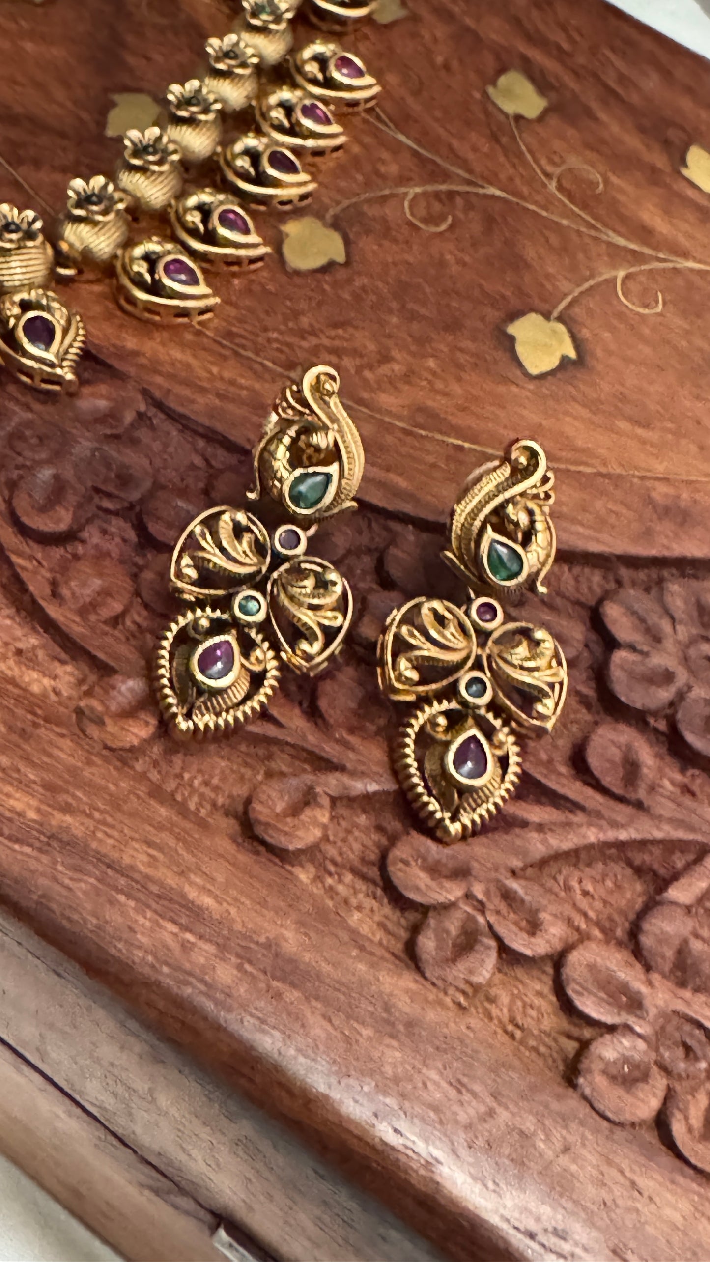 Temple Jewellery with emerald, ruby and white color stone details.