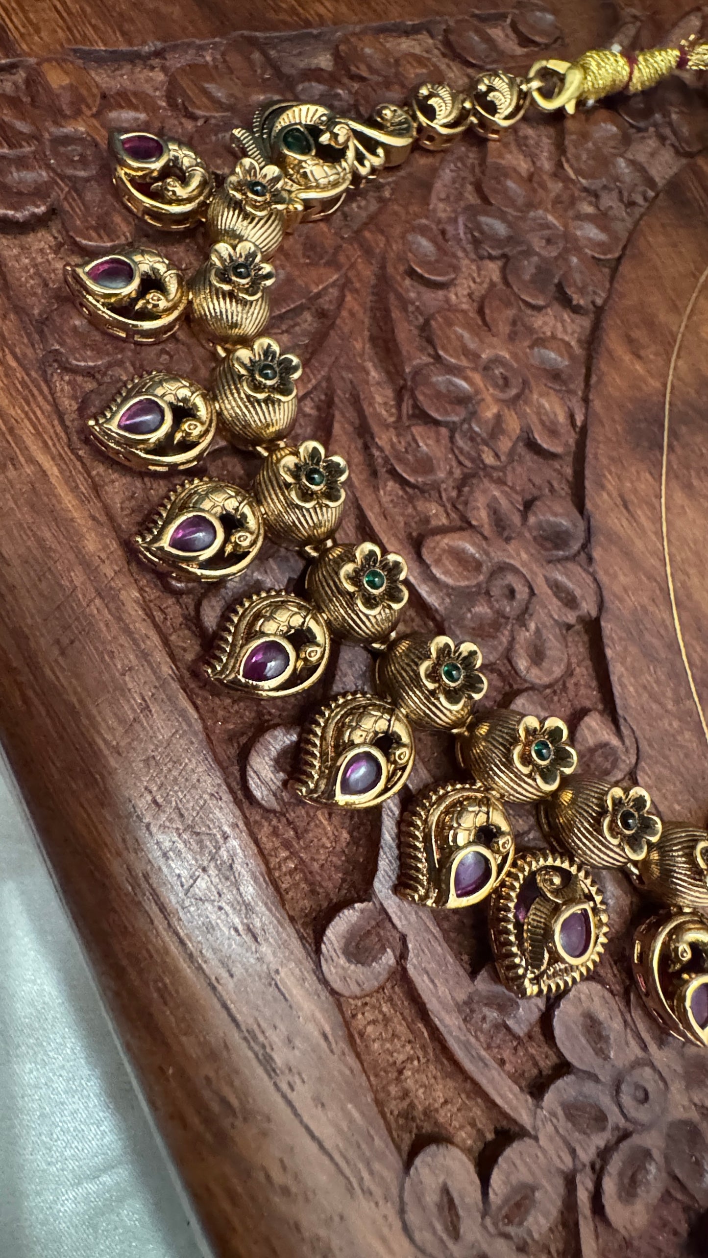 Temple Jewellery with emerald, ruby and white color stone details.