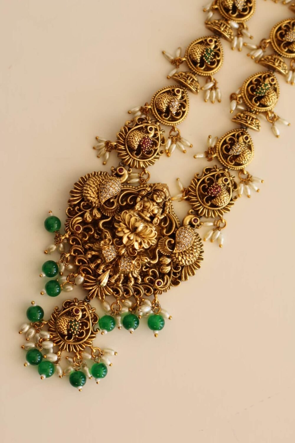 Long Bridal Temple Jewellery with pearl emerald,and ruby color stone details.